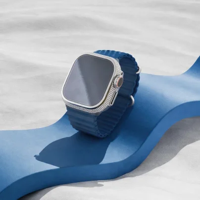 Luxury smartwatch with diamond bezel and blue strap on abstract background