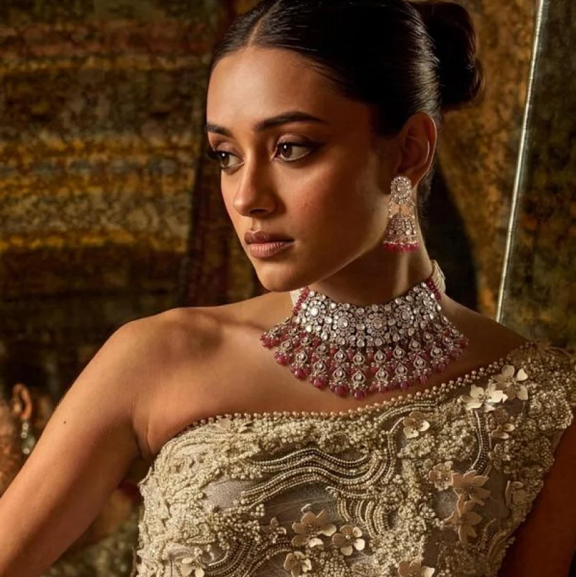 Woman wearing ruby and polki bridal choker necklace with statement earrings